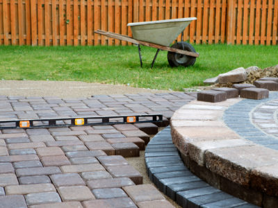 Wehn building a patio prepare to use level and barrel constantly, patio island have polymeric sand layed and job completion almost done when final pavers cut and placed