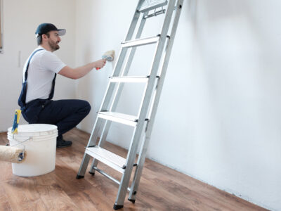 Professional painter worker is painting a wall